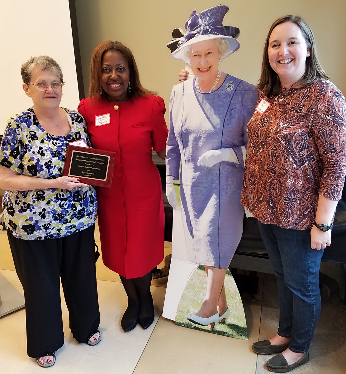 On Saturday, October 20th, 2018, Massachusetts Friends of Libraries awarded the Friends of the Millis Public Library its Donna Forand Fantastic Friends Award for 2018 for its special event Royal Wedding Tea. Shown with “Queen Elizabeth,” from left, are Massachusetts Friends of Libraries President Alice Welch, Millis Friends’ President Sandra Elaine Scott, and Millis Friends’ Treasurer Meghan Gavaghan.