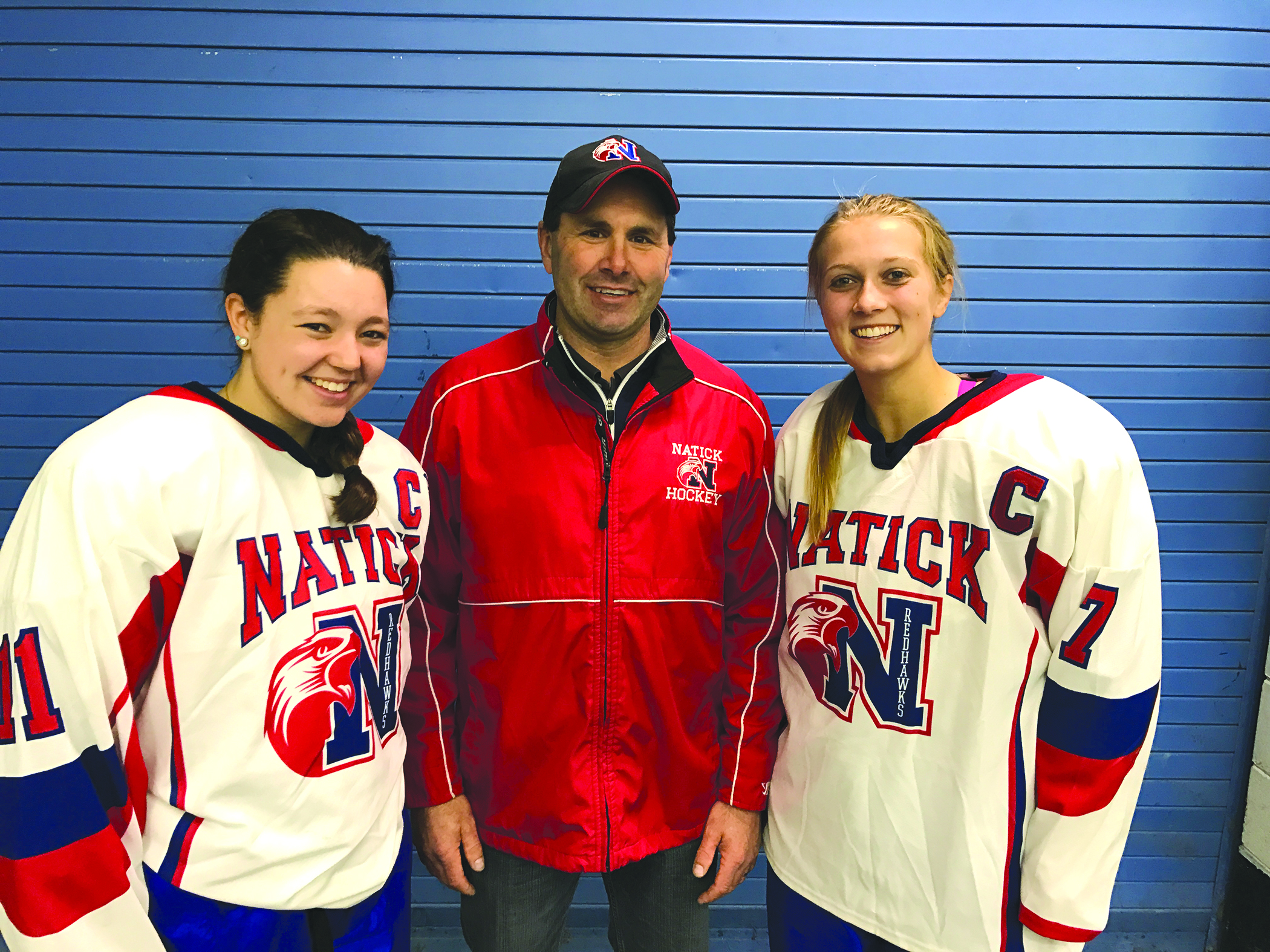 Natick coach Bruce Ihloff with two of his captains – Sophie Burr, left, and Mikayla Quigley, right. Missing from the photo is captain Anna Rausch.