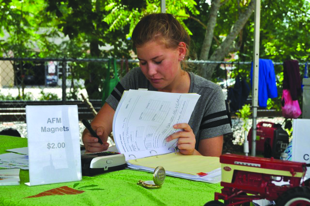 Student Eva Bruklich works as a volunteer market manager. (photo/Eric Brooks)