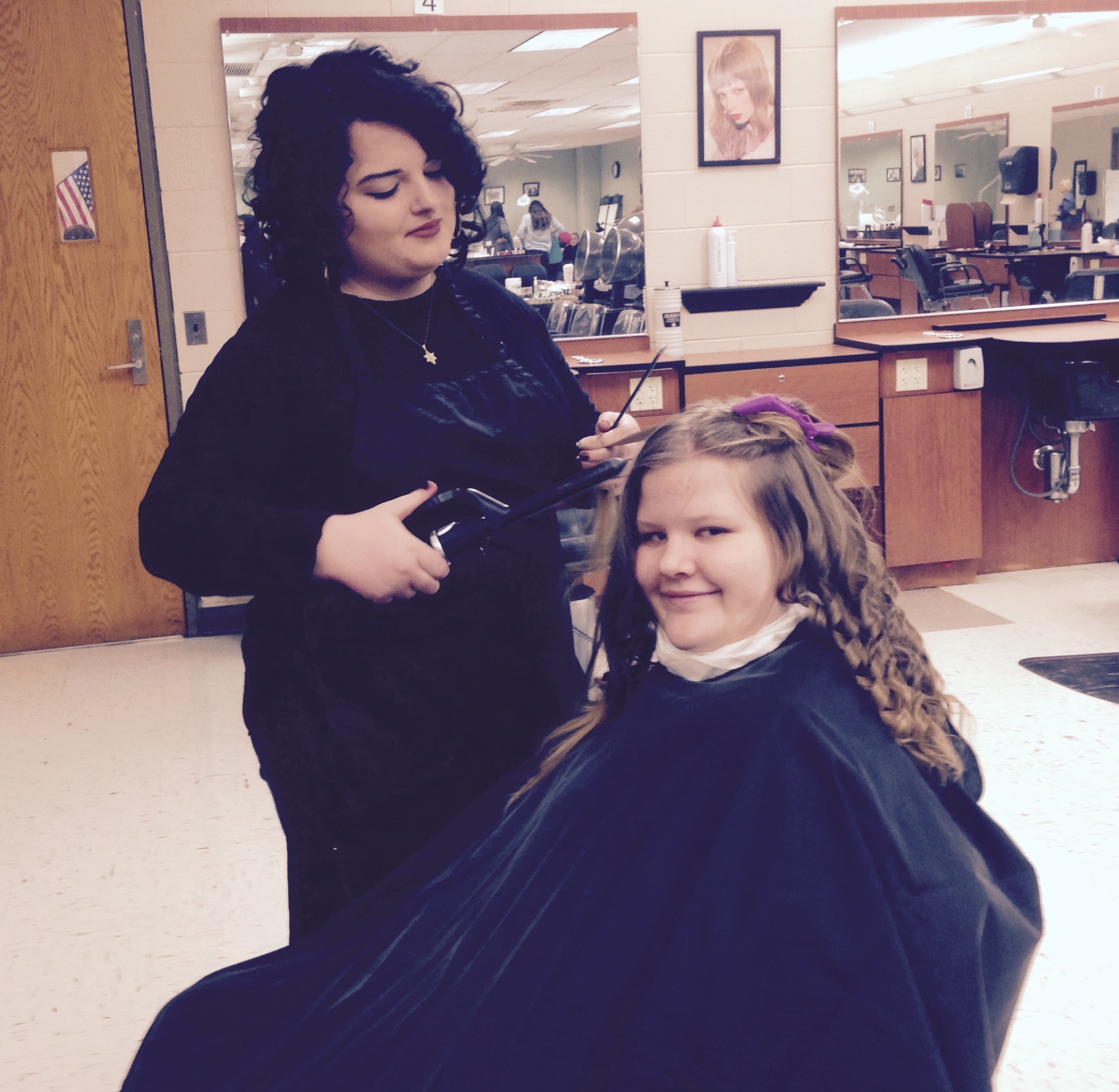 Tri-County cosmetology student Grace Kaluzny, in 11th grade, puts finishing touches on Meaghan Harmon’s (FHS 9th grader) prom hairdo. 