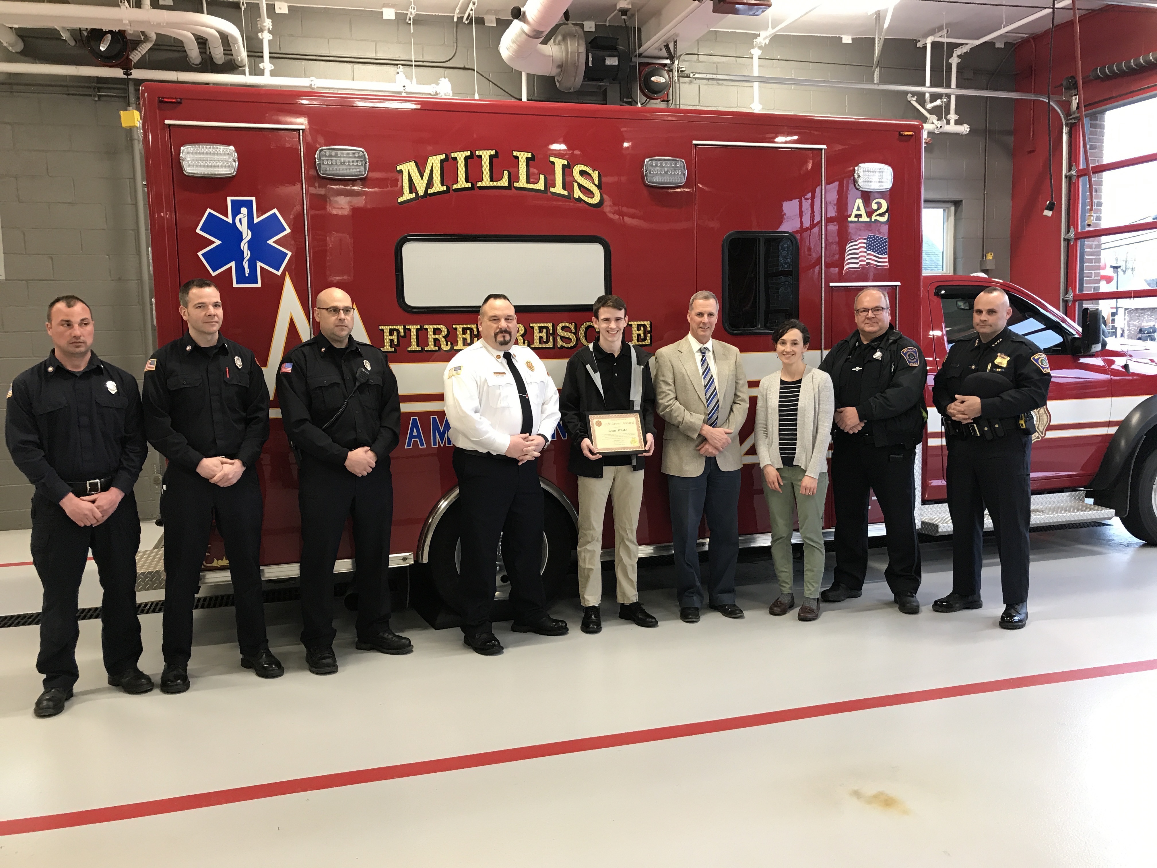 Millis High School student Sean White received a life saver award from Millis Fire Department on February 7th, 2019. From left, Millis FF/EMT Mike Scotland, Millis FF Joe Sullivan, Millis FF Brian Polimeno, Millis Fire Chief Rick Barrett, Sean White, Millis HS Principal Robert Mullaney, Millis Math teacher Rachel Alan, Millis Police Officer & EMT Peter Opanasets, Millis Police Chief Chris Soffayer