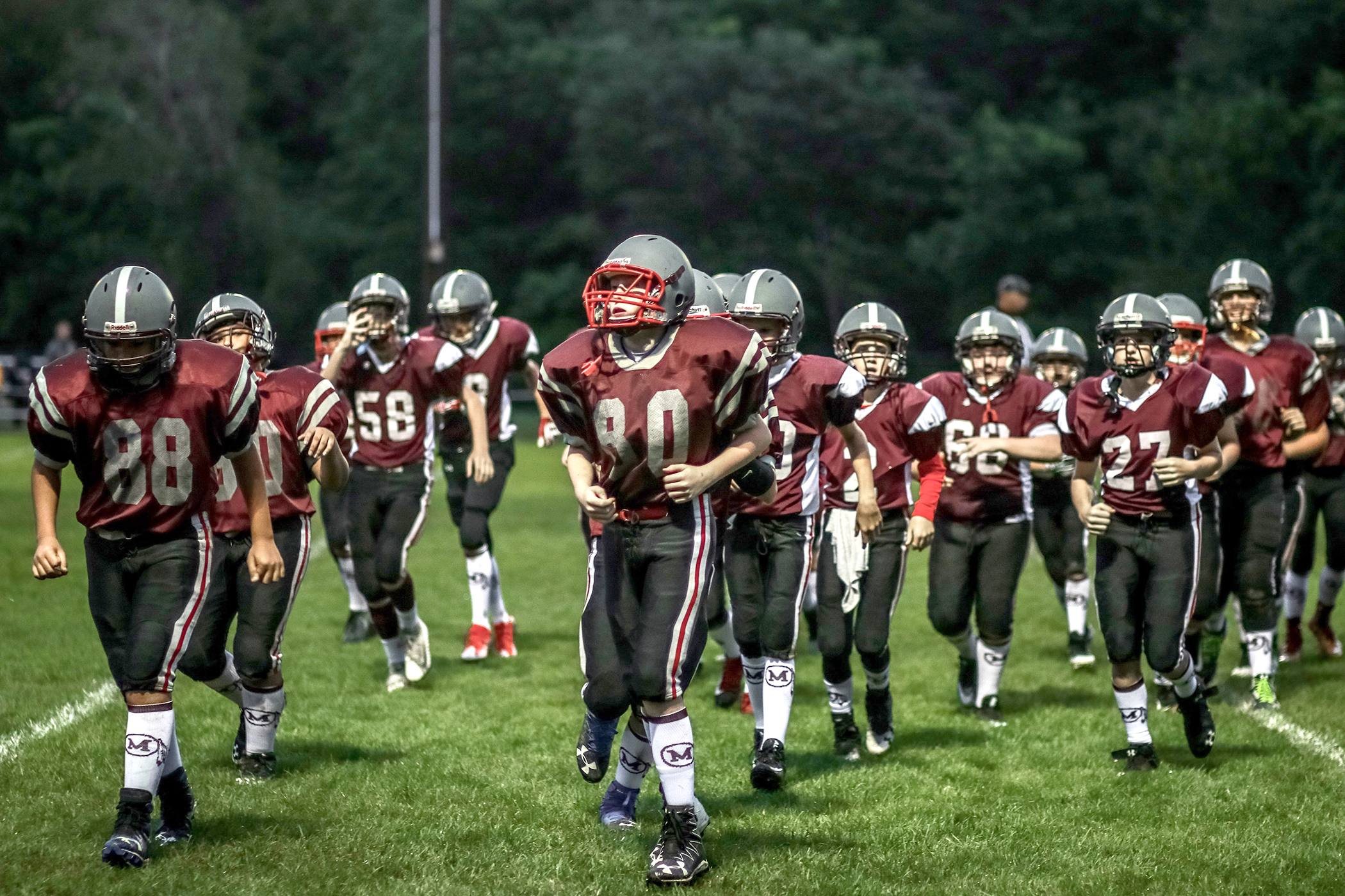 Shown are Millis middle school football players, who might one day play for the high school team. Brian Kraby, a teacher at Millis High School, is putting together a youth football and cheer program for even younger students, aged 9-12, in 4th, 5th and 6th grades, in the hopes of strengthening the town’s overall football program.  Photo by Adriana Arguijo Photography