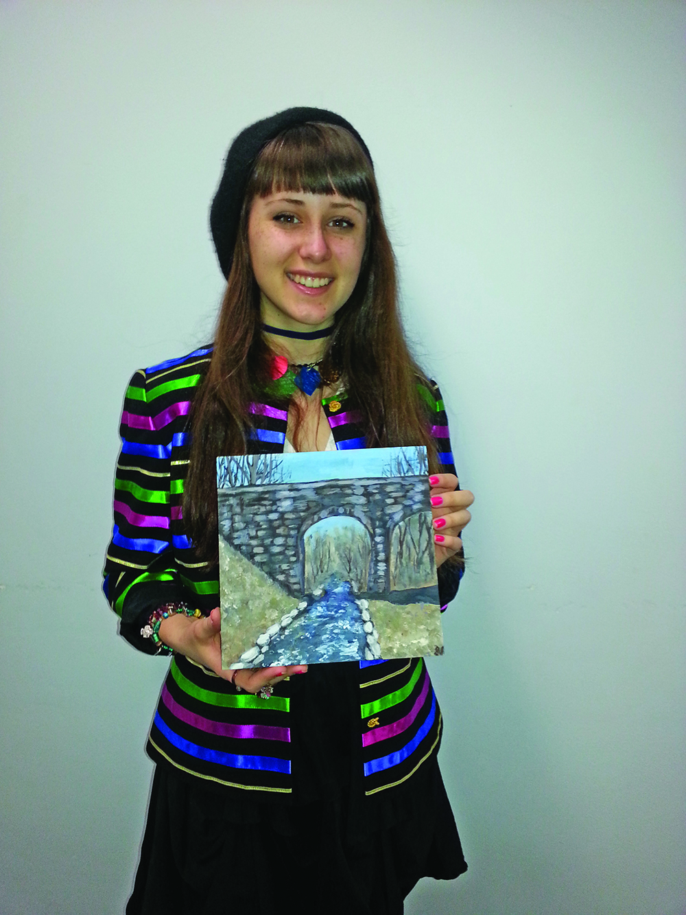 Holliston High School artist Samantha Tate has volunteered to do an art project with younger Holliston students around the theme of the 8-Arch Bridge. Here, she, holds one of her interpretations of the 8-Arch Bridge.