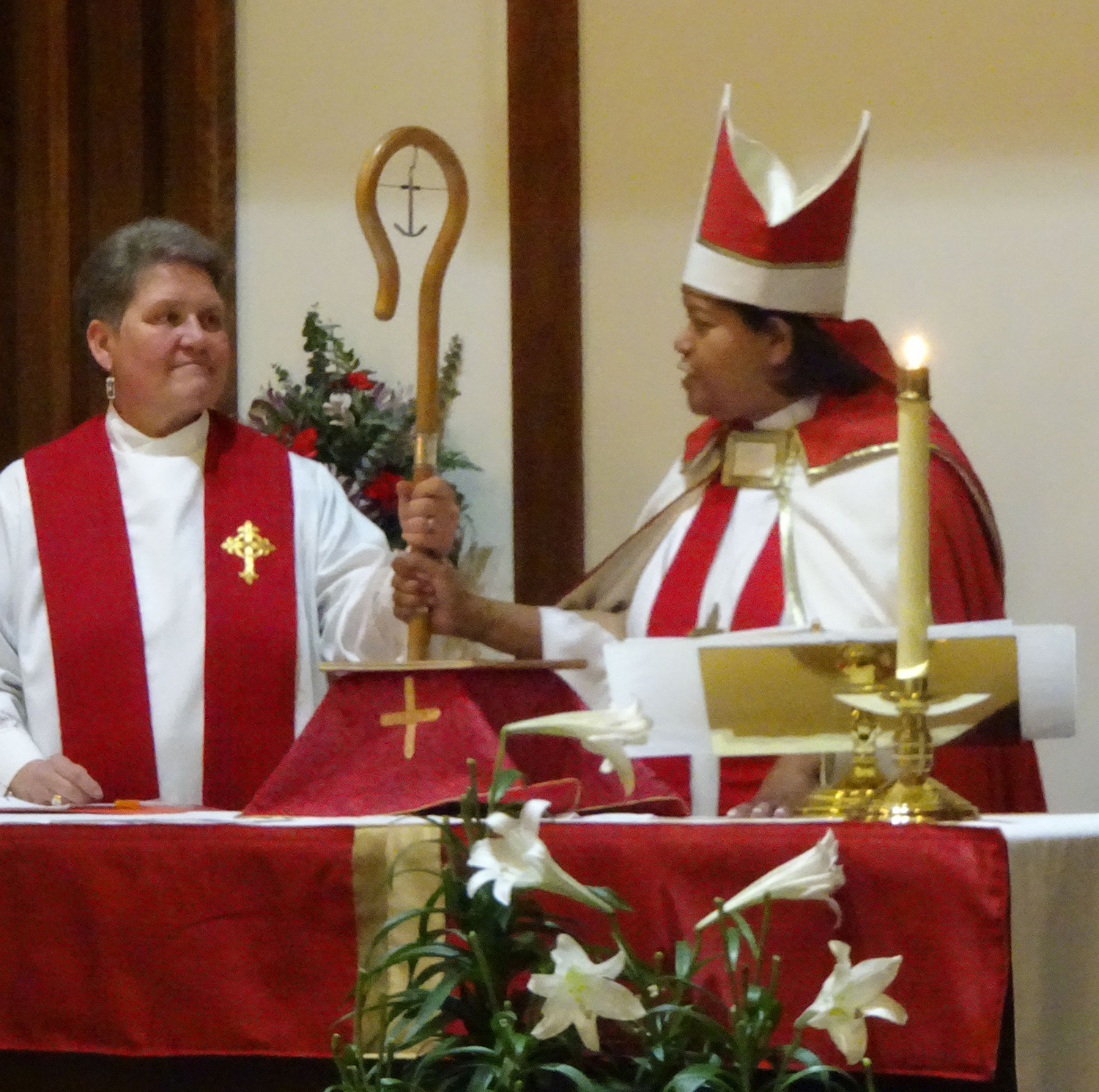 L-R-Rev. Kathy McAdams with Bishop Suffragan Gayle E. Harris, together hold the bishop’s Shepard’s crook. “Be my representative to care for the people of Franklin,” the Bishop exhorted McAdams