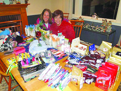 St. Michael’s Episcopal Church Annual Auction supports a number of local, national and international causes, such as this “Stockings of Hope” effort during the holidays. Shown here are Paula Colburn and Pamela Pinterparsons. The event will take place this year on April 9. 